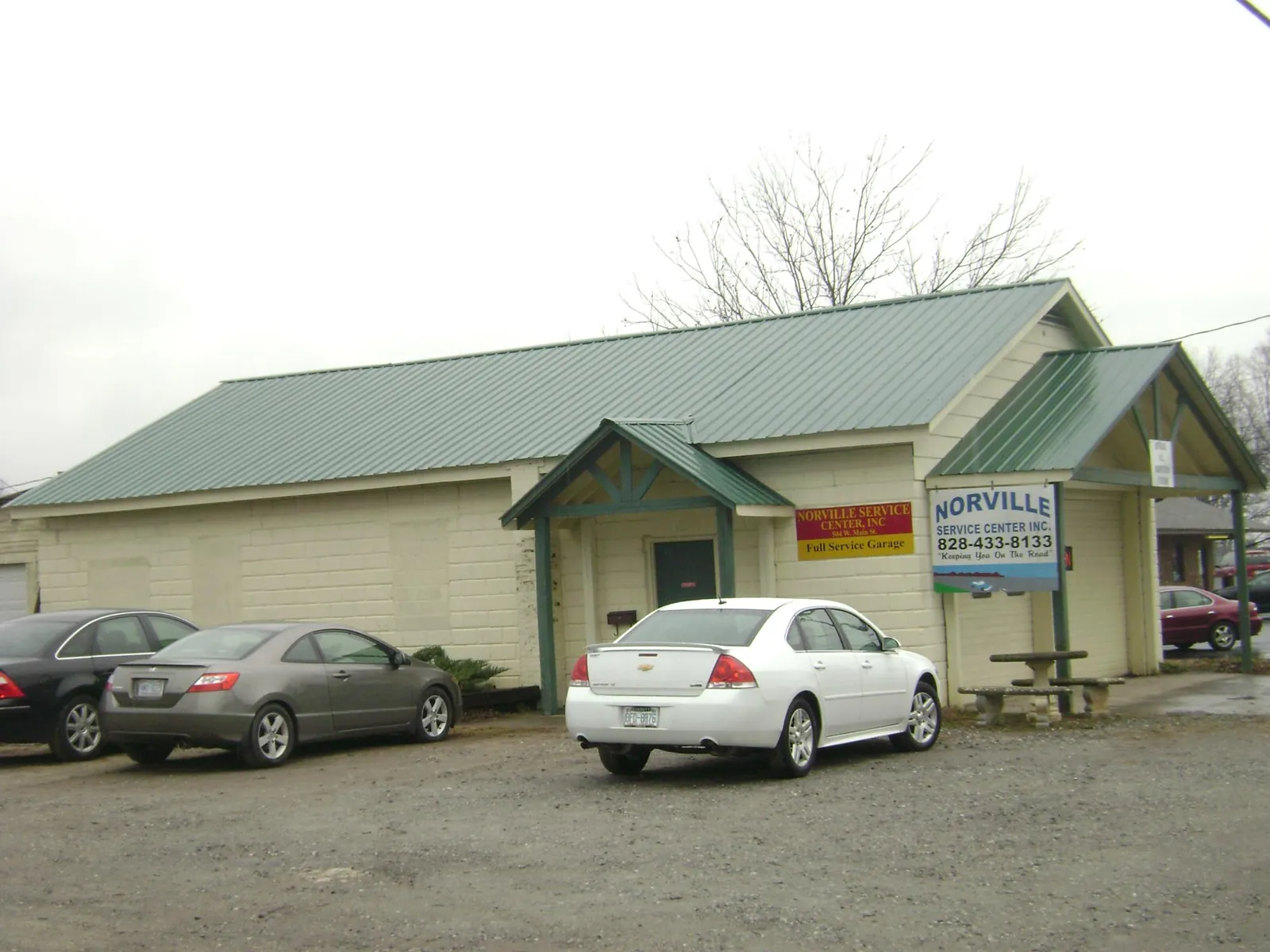 Green metal roof on a service garage with a covered entry in Joplin